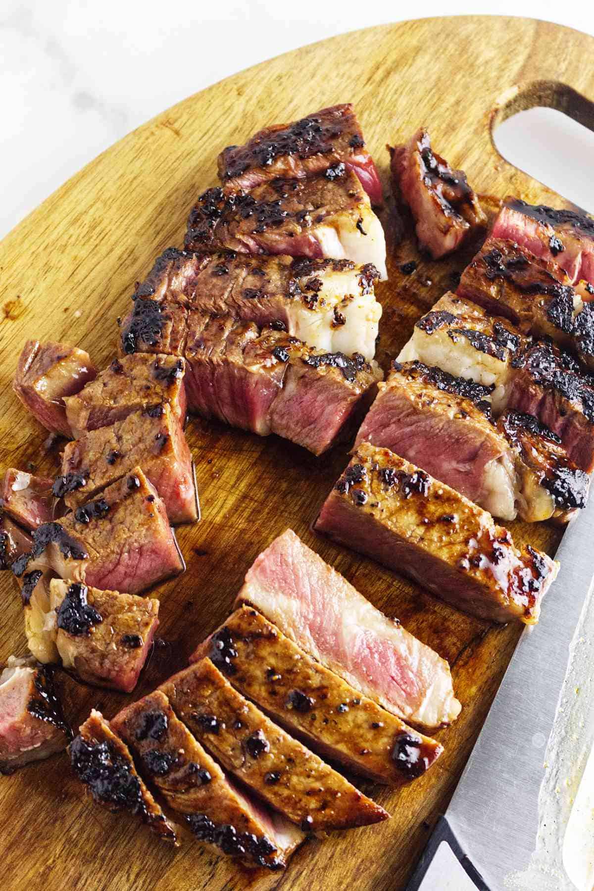 cut Blackstone grilled beef Teppanyaki on a cutting board.