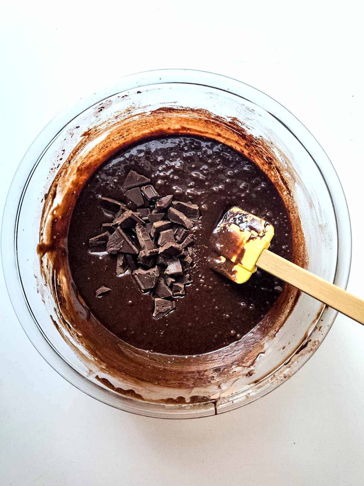 brownie batter mixed with chopped chocolate pieces.