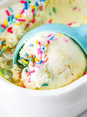 scooping funfetti ice cream from storage container.
