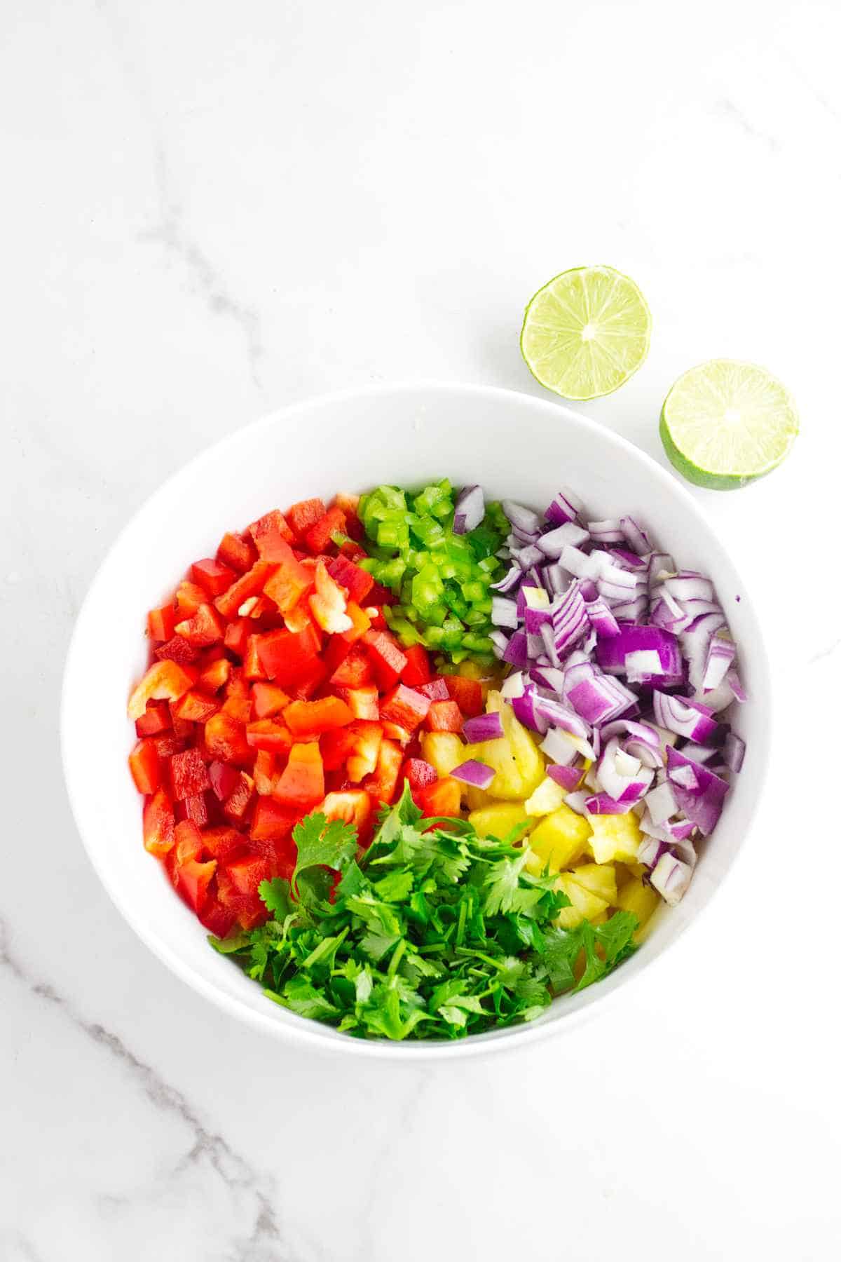 bowl of colorful chopped fruit and vegetables.