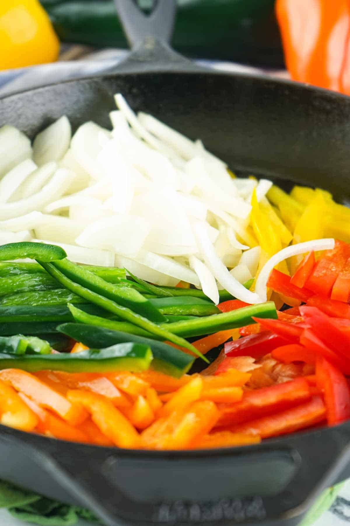 cut vegetables in a cast iron pan.