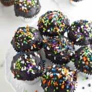 cupcakes with black buttercream and sprinkles.