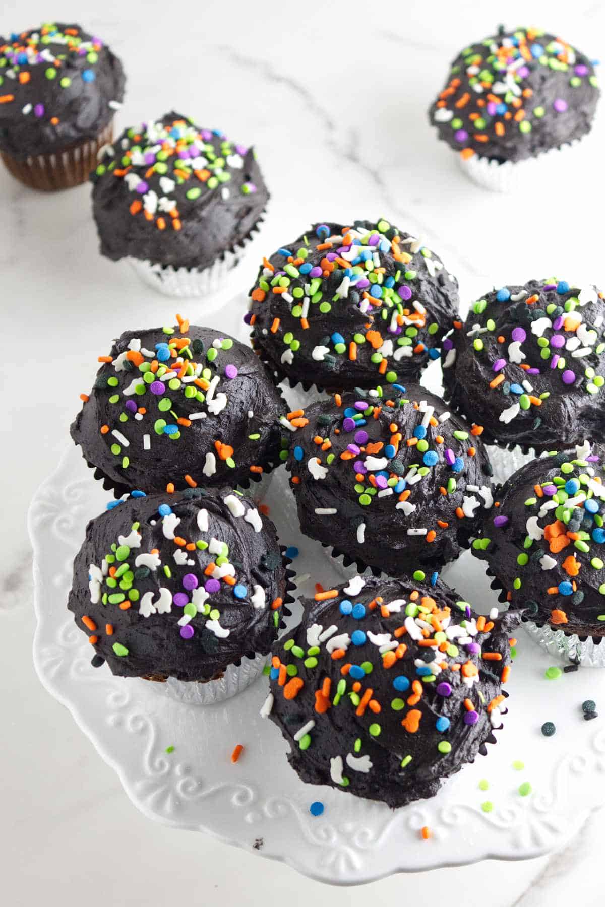 cupcakes with black buttercream and sprinkles.