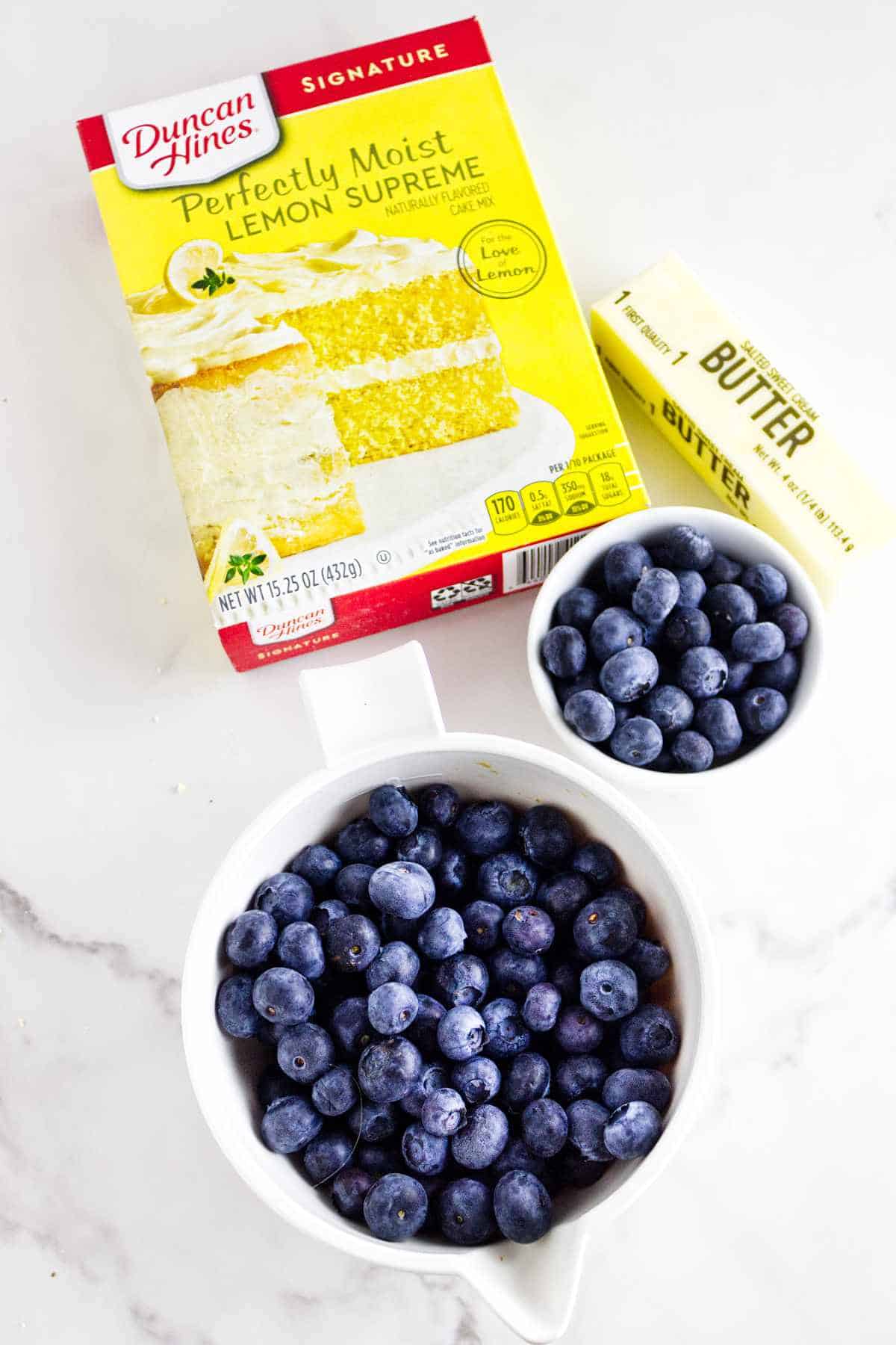 lemon cake mix, stick of butter, and fresh blueberries.