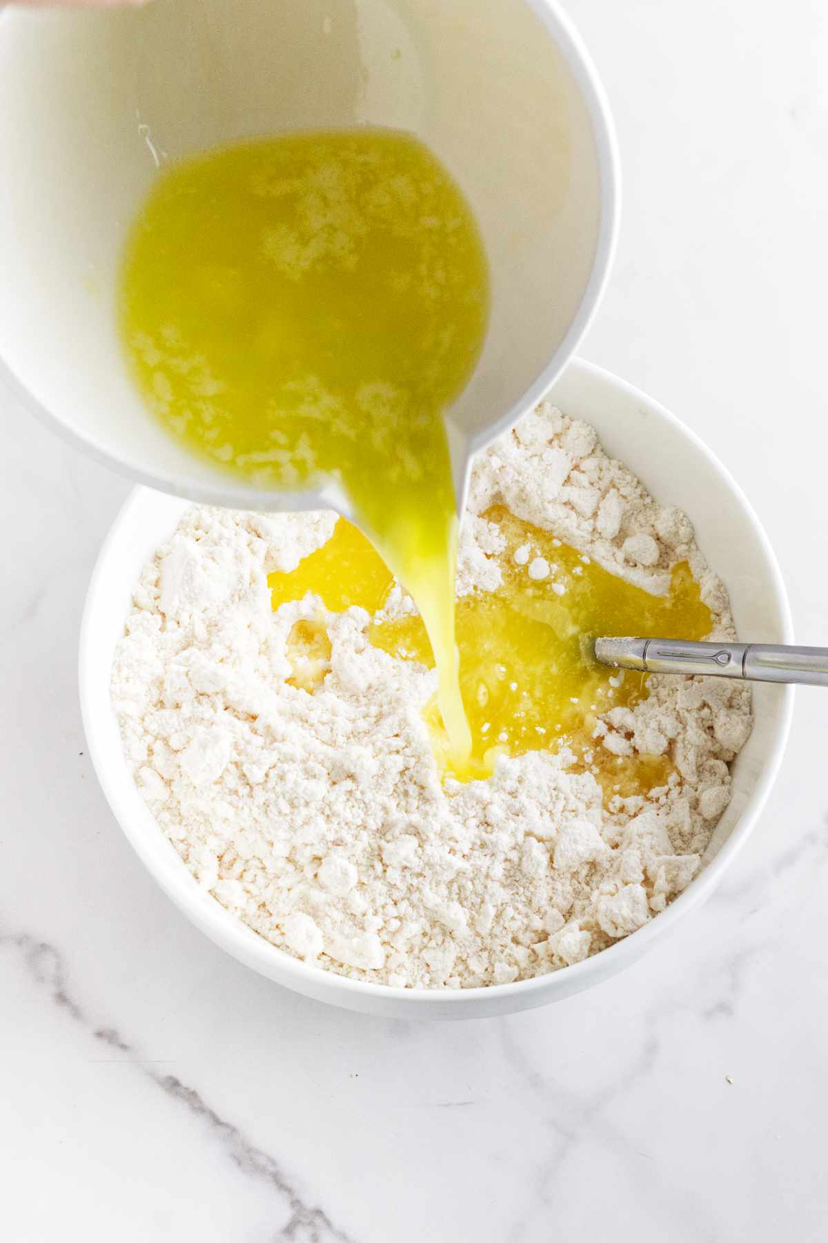 melted butter in a bowl of flour mixture.