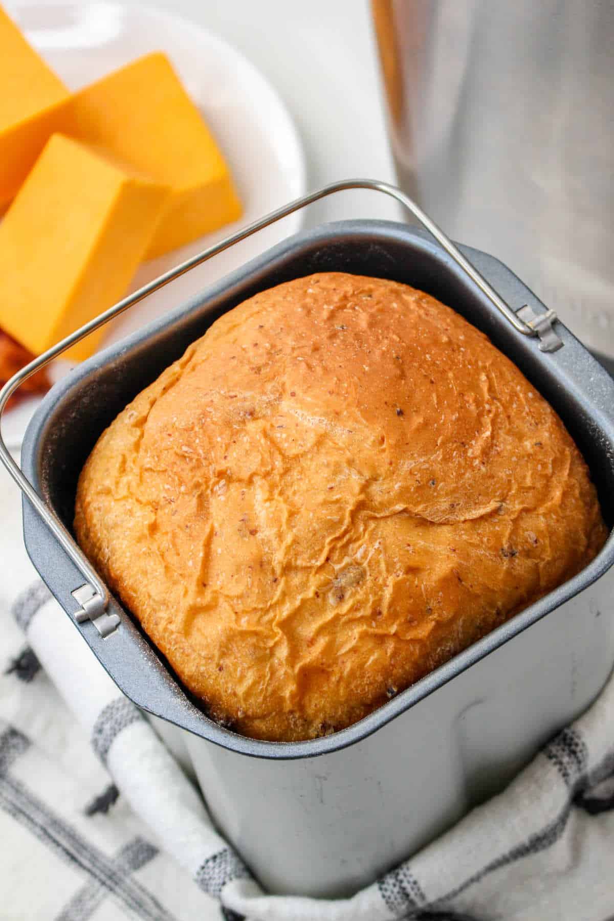 golden brown bread in a vertical baking pan.