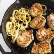 cast iron seared pork tenderloin medallions with onions.