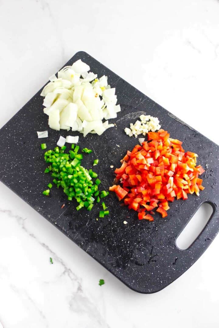 Diced jalapeno, bell pepper, and onion prepared for chorizo refried beans.