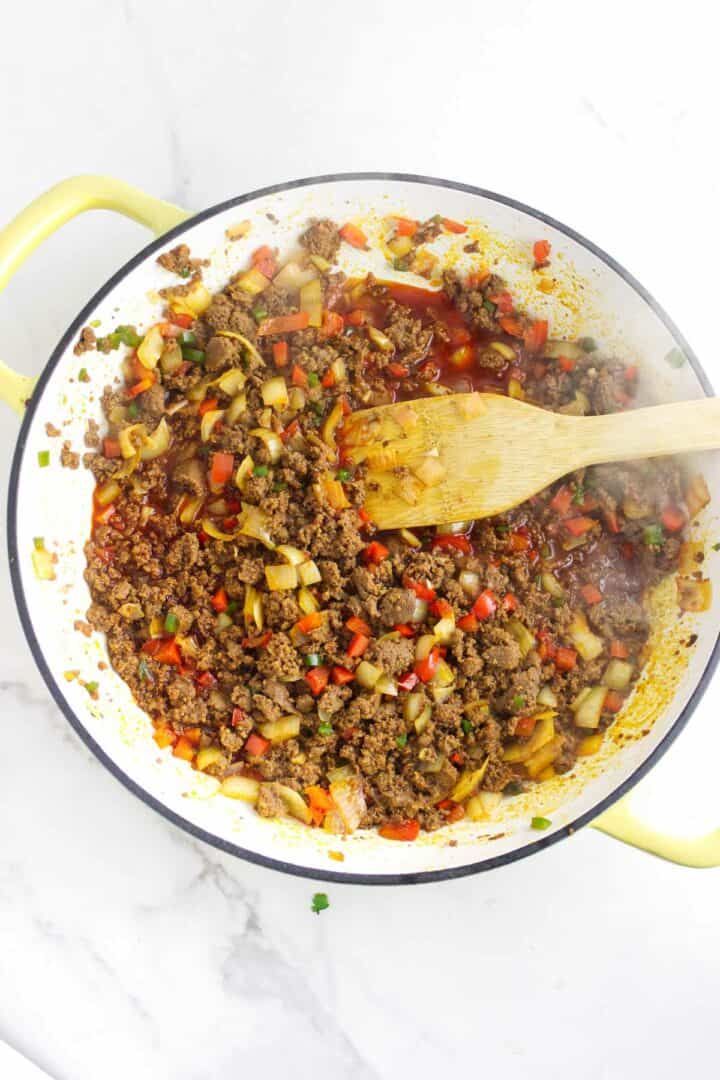 Sofrito mixture cooking with chorizo until softened and fragrant.