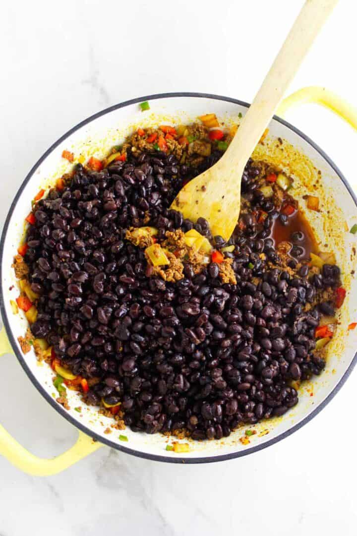 Black beans added to chorizo mixture and partially mashed to create creamy texture.