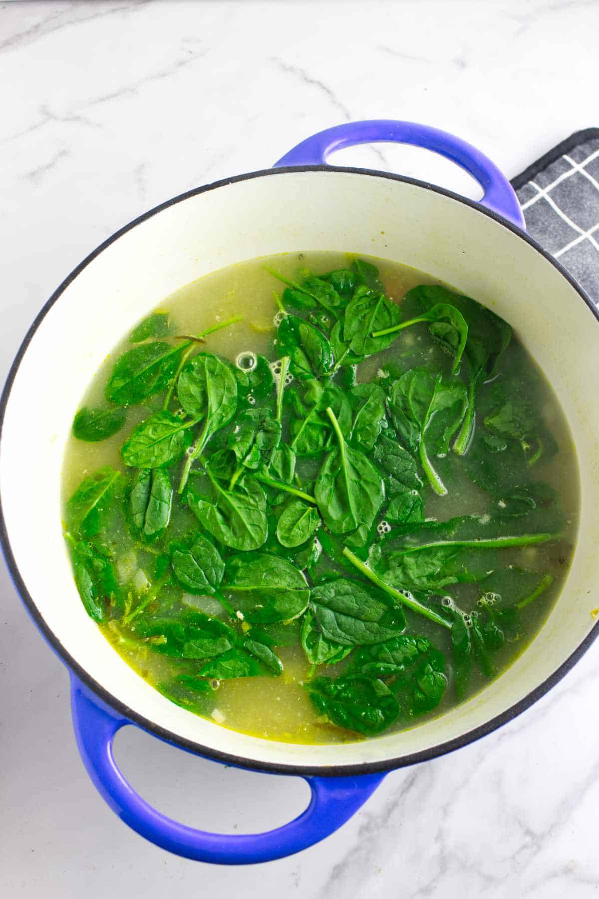 Spinach and orzo added to soup pot.