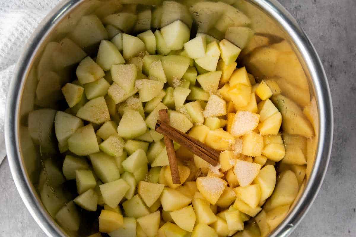 diced peeled apples, sugar, and cinnamon in a cook pot.