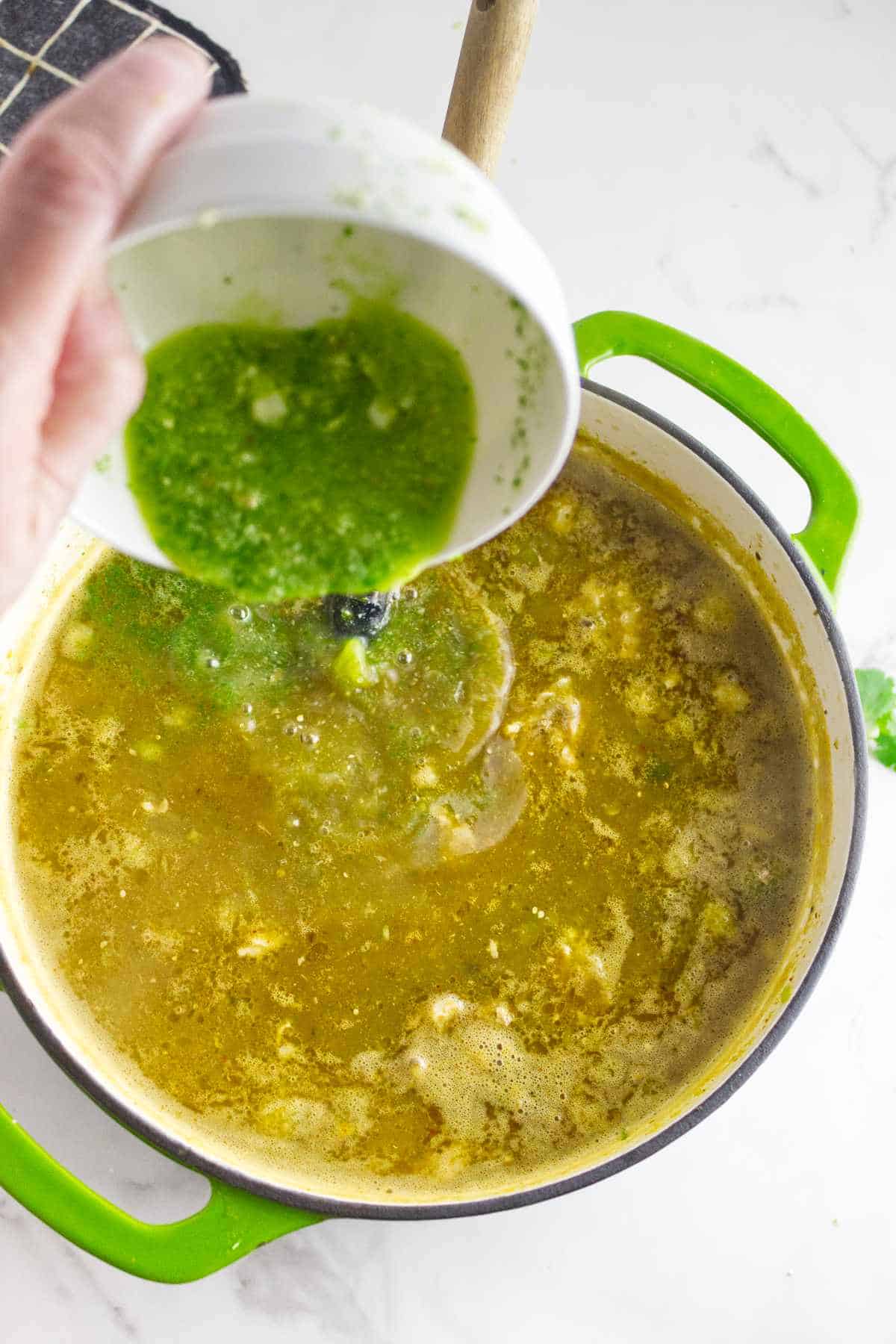 hominy thickener added to pot of pork pozole verde.