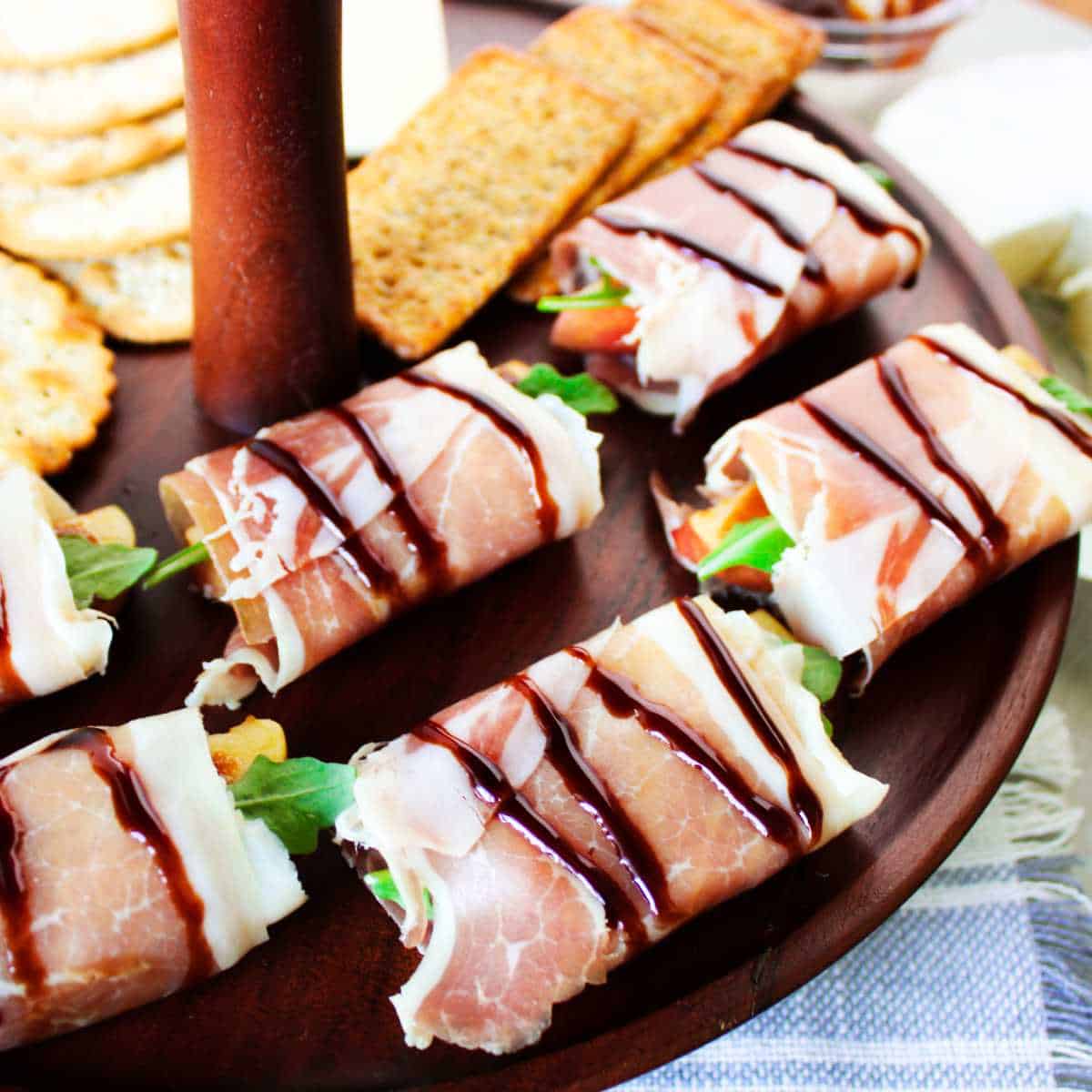 prosciutto wrapped bundles of apple and cheese drizzled with balsamic glaze.