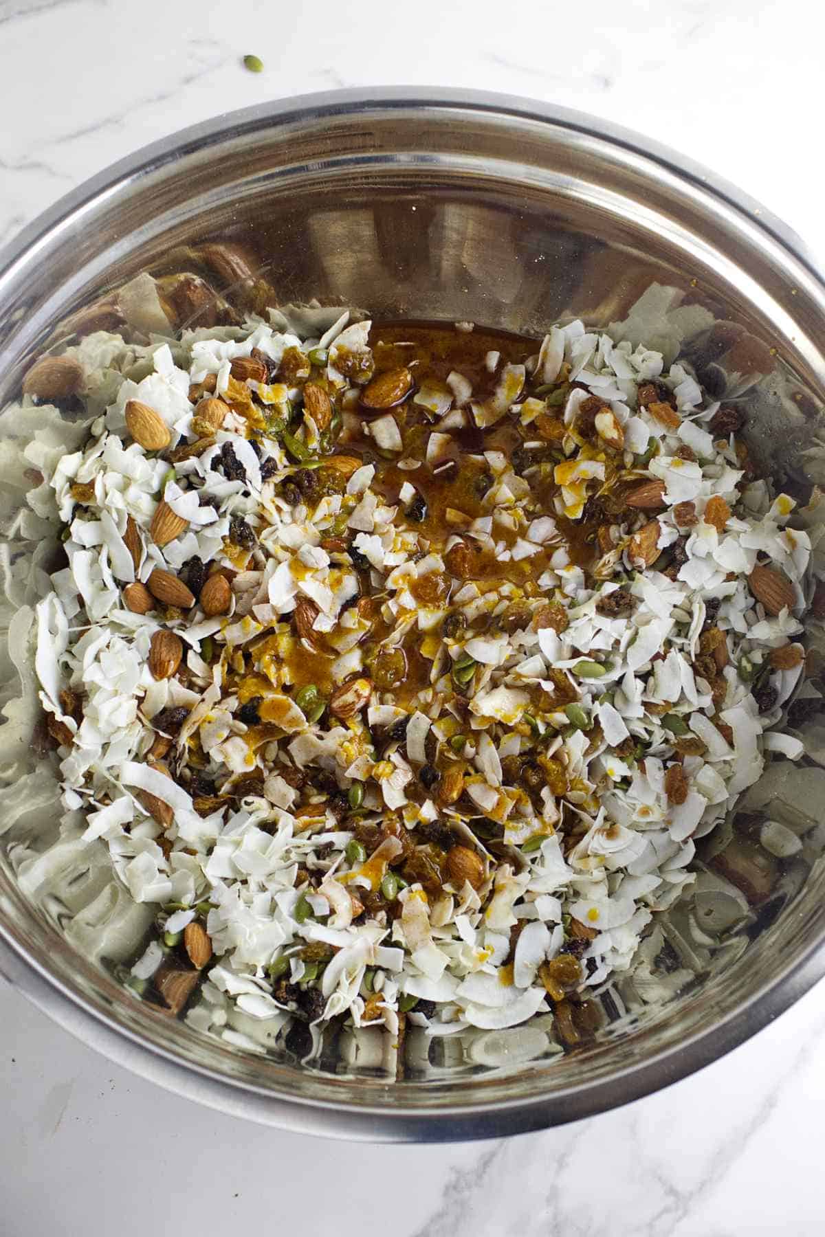 pumpkin, maple syrup, and coconut oil added to fluffy coconut and seeds.