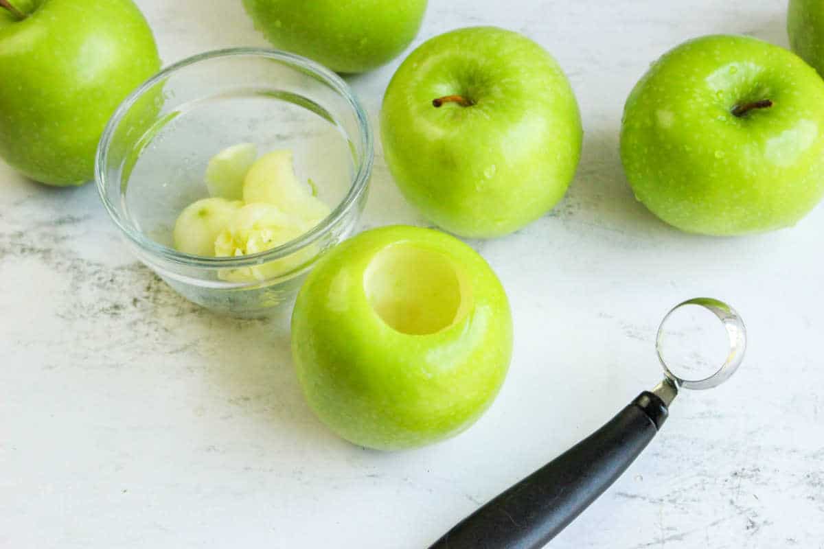 cored Granny Smiths on a white work surface.