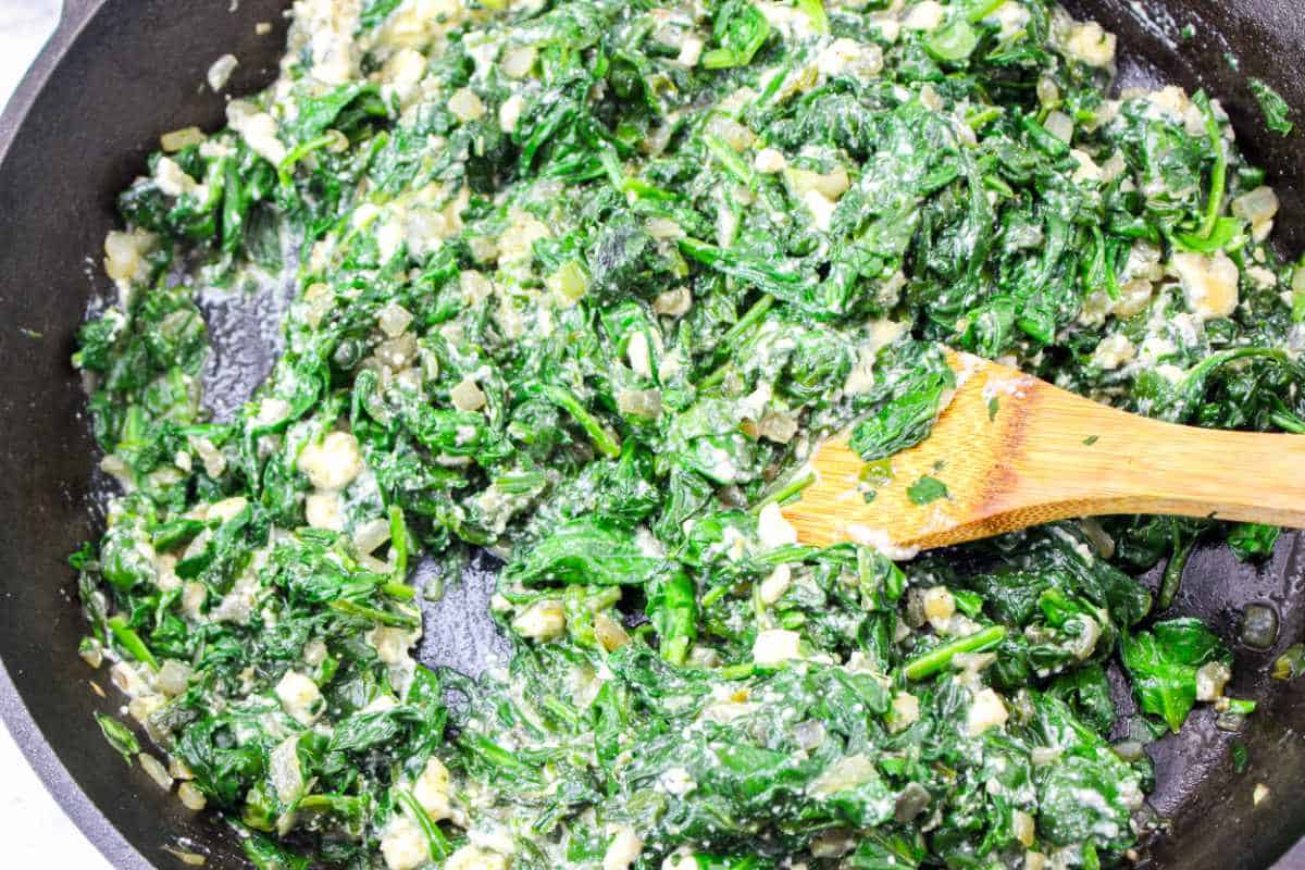 cheese filling added to sauteed spinach.
