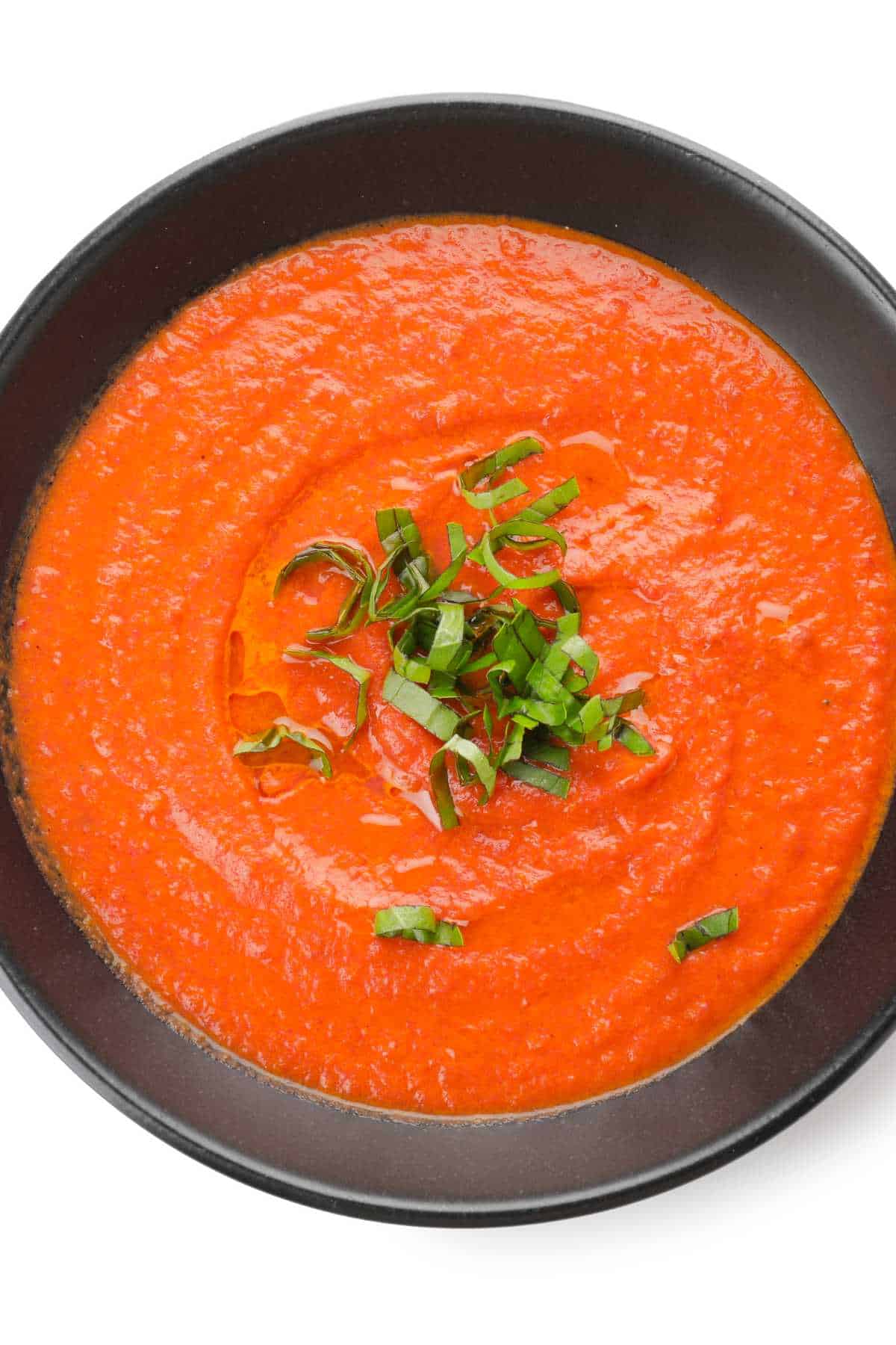 Bowl of tomato cream soup isolated on white background for Fall Soup Round up.