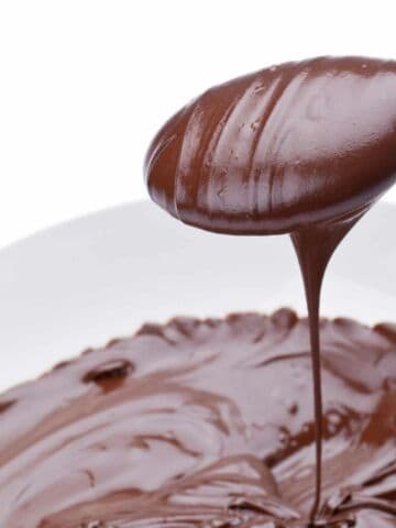 a spoon scoop in melted chocolate.
