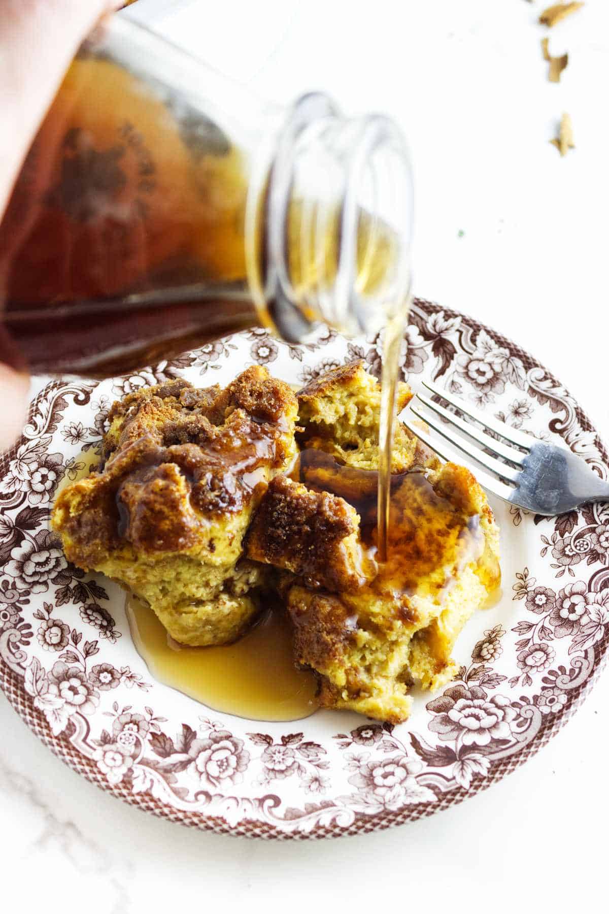 maple syrup poured over a serving of french toast casserole.