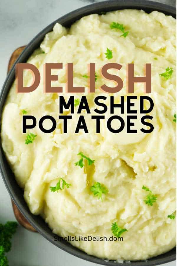 bowl of mashed potatoes with parsley sprinkled on top.