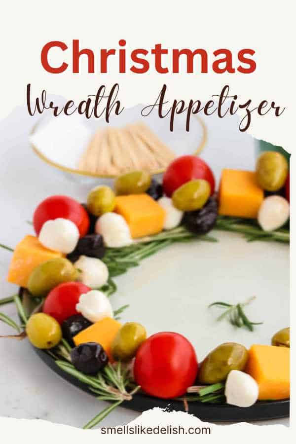 cheese, olive, and cherry tomato appetizer shaped as a Christmas Wreath.