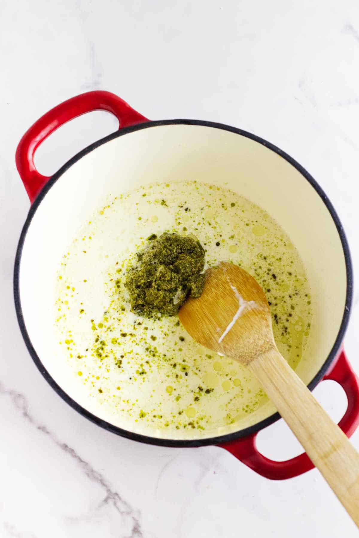 pesto, seasonings, and cream added to dutch oven.