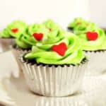 Red candy hearts on grinch green buttercream iced cupcakes.