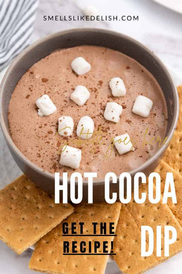bowl of hot cocoa marshmallow cookie dip with graham crackers nearby.