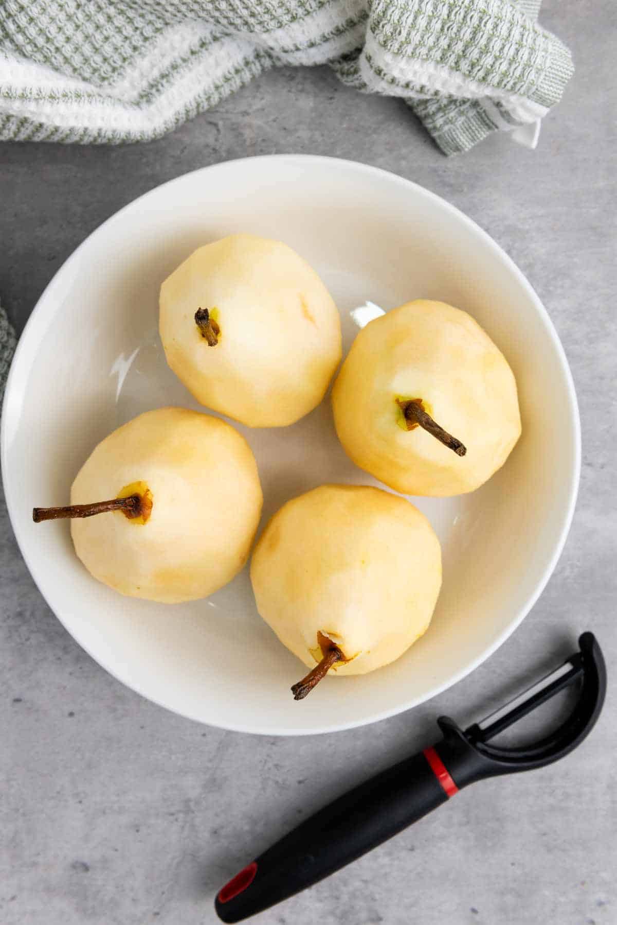 peeled pears in a bowl.