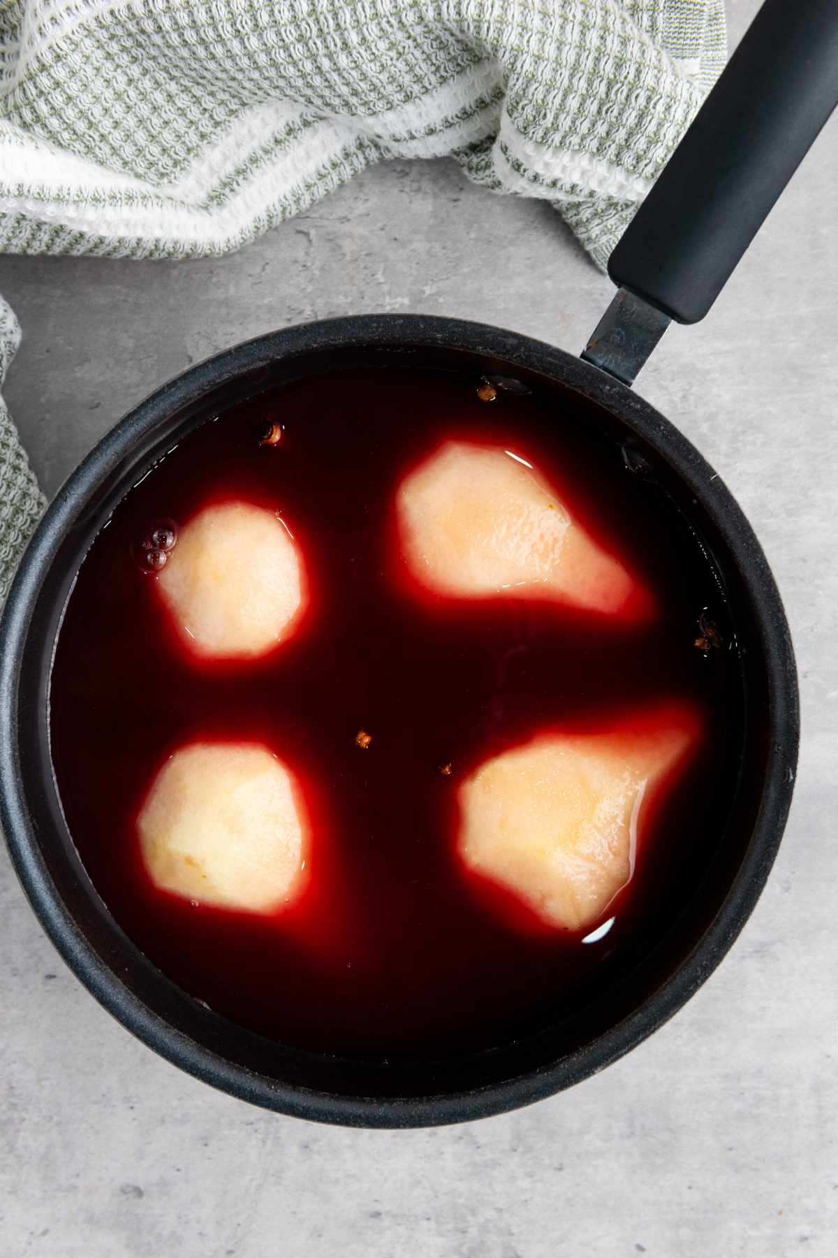 pears in the sauce pan of wine.
