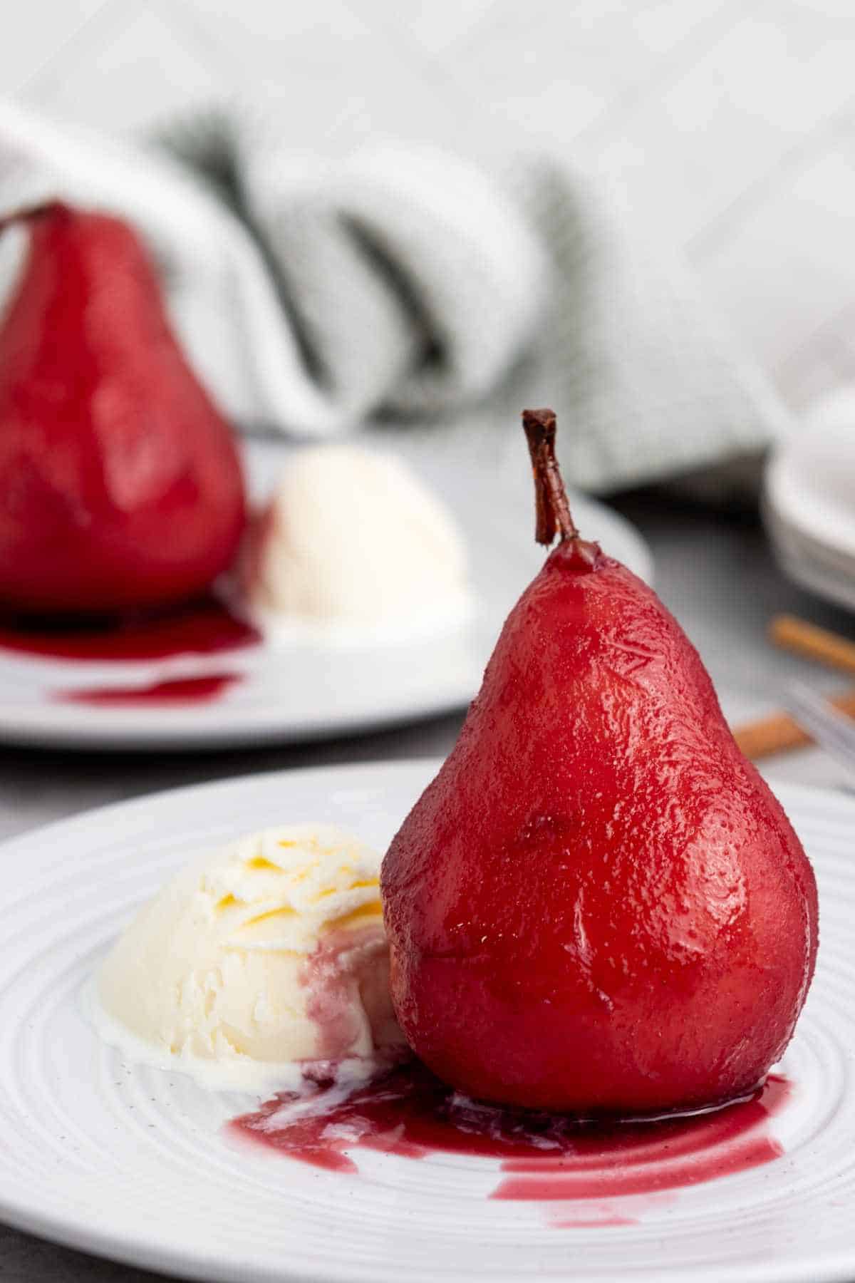 plates with wine poached pears and ice cream.