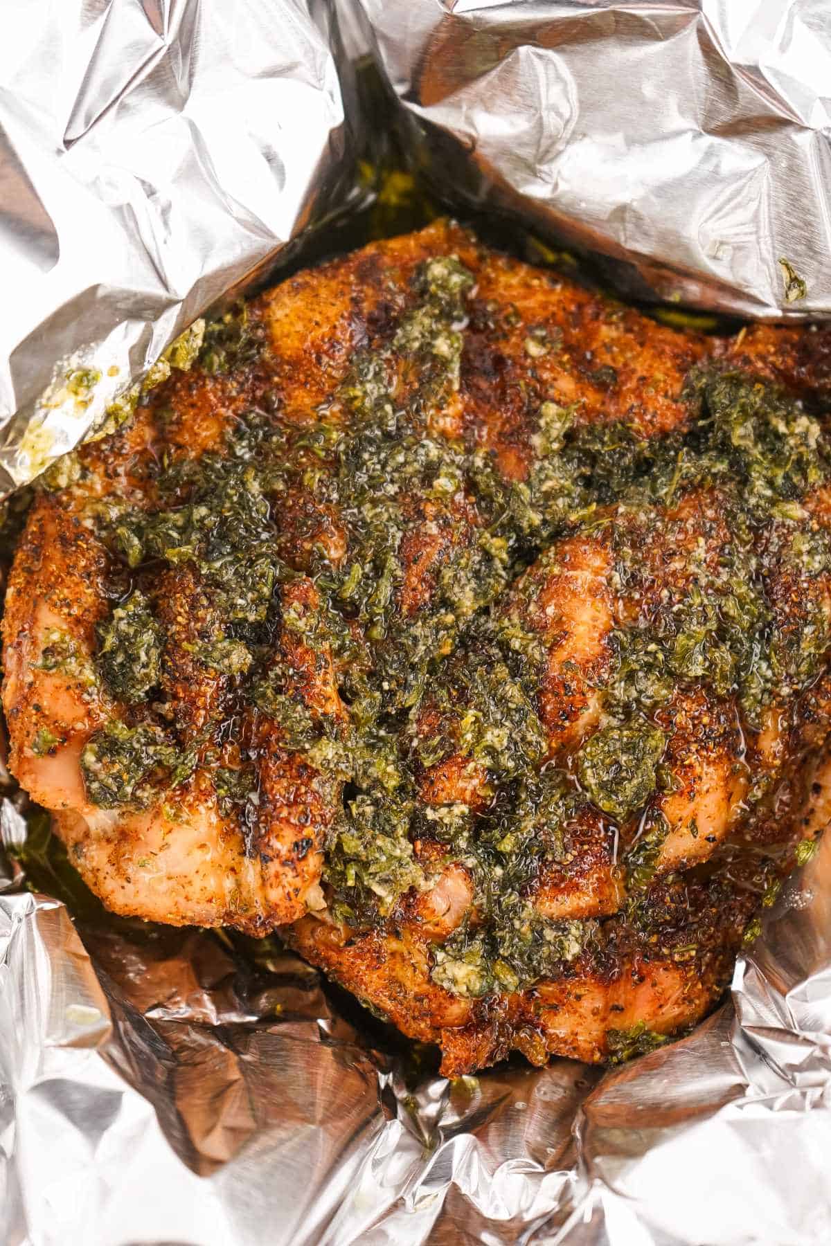 smoked turkey breast with herb crusted top in aluminum foil.