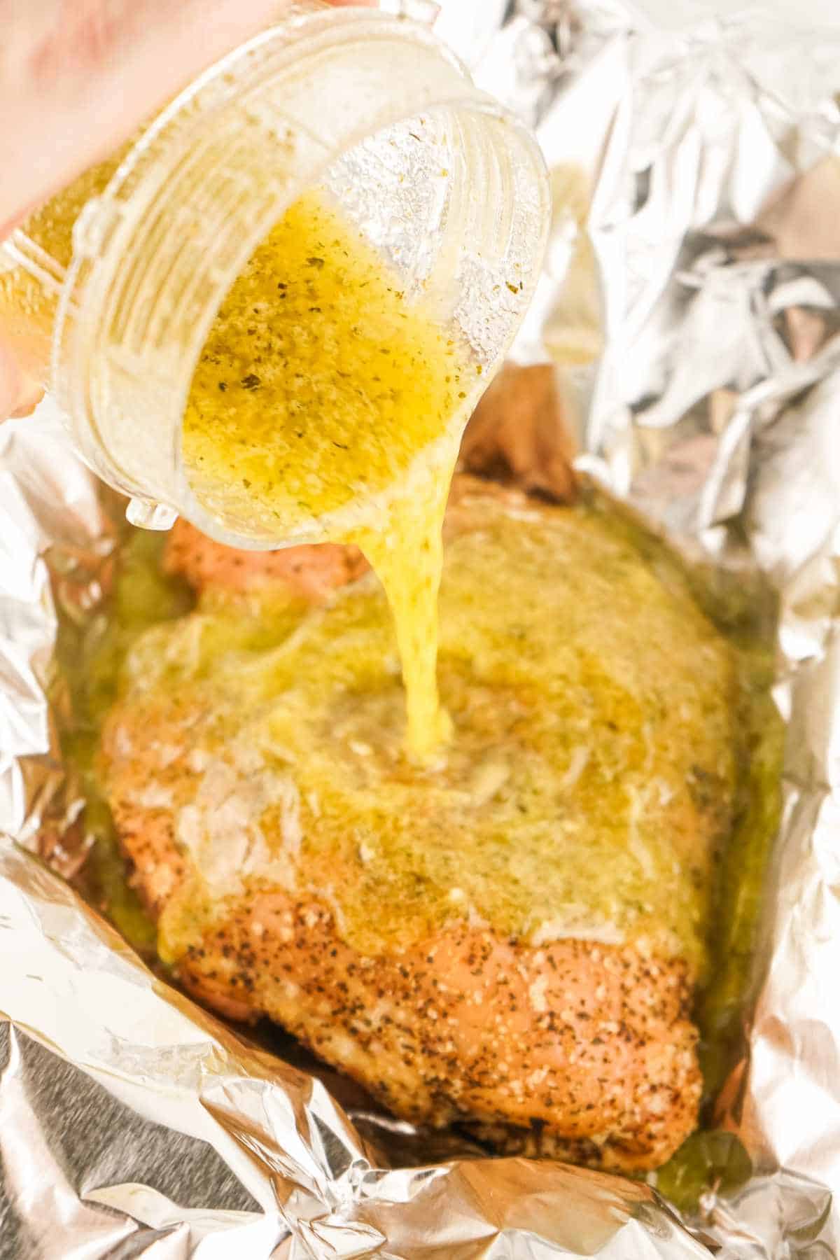 aromatic butter poured over foil wrapped turkey.