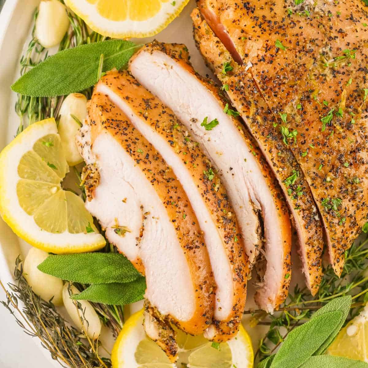 sliced herbed turkey on a platter.