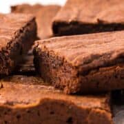 pile of hersheys cocoa brownies on a plate.