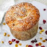 Fresh baked Panettone fruit cake with powdered sugar dusting.