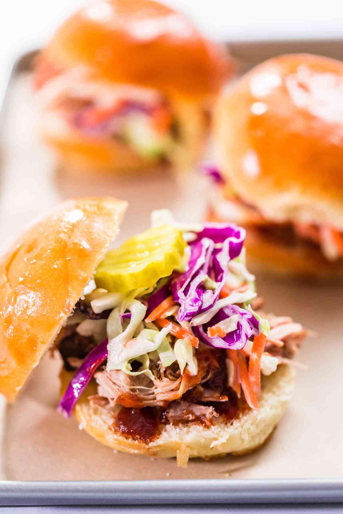 BBQ pulled pork sandwich in shape of small sliders with brioche buns.