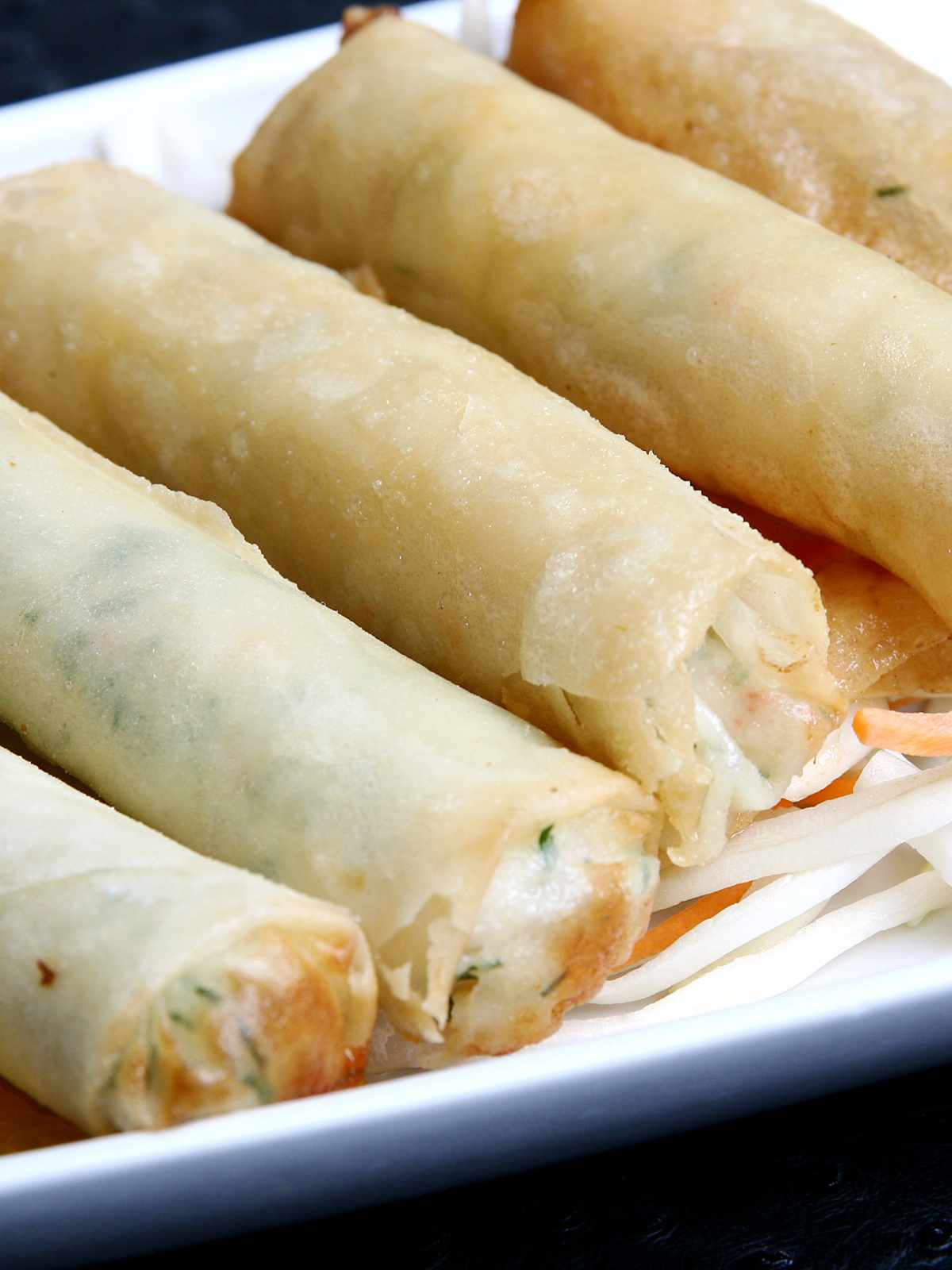 tray of lumpia served with dipping sauce.