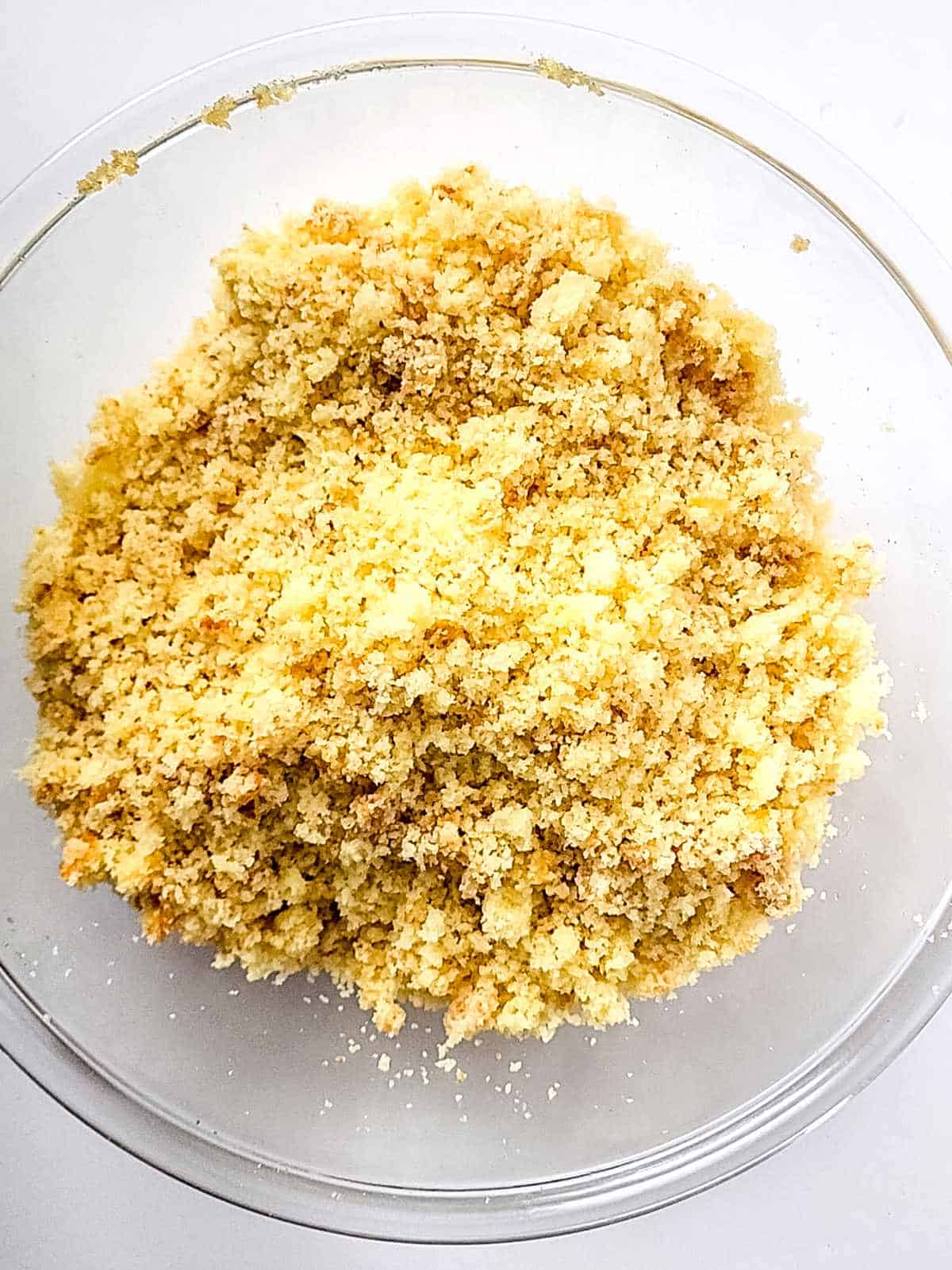 yellow cake crumbles in a bowl.