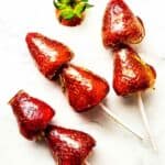 skewered strawberries dipped in sugar syrup for crackly tanghulu.