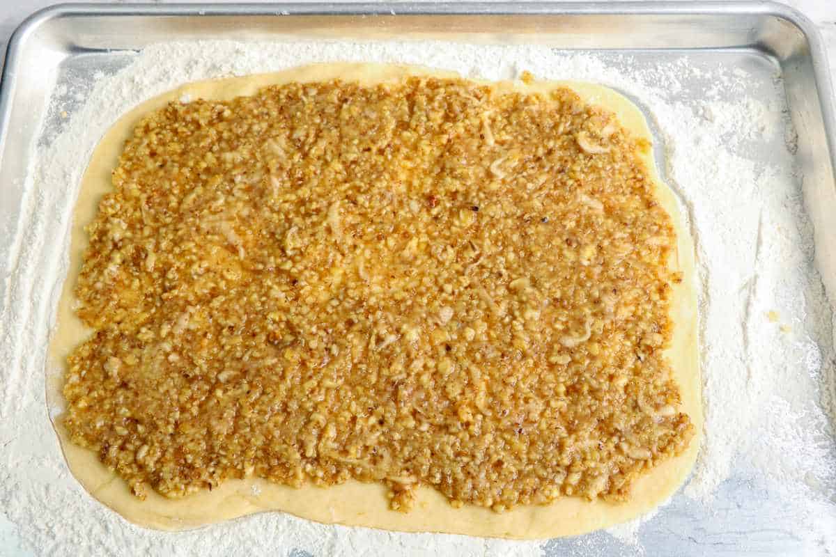 walnut filling spread out on rolled out dough.