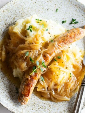 Bangers and cauliflower mash on a plate.