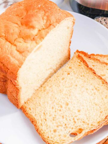 Sliced bread maker sandwich bread on a plate.