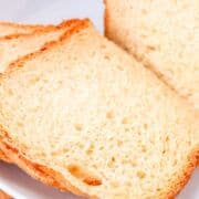 Sliced bread on a plate, perfect for sandwiches.