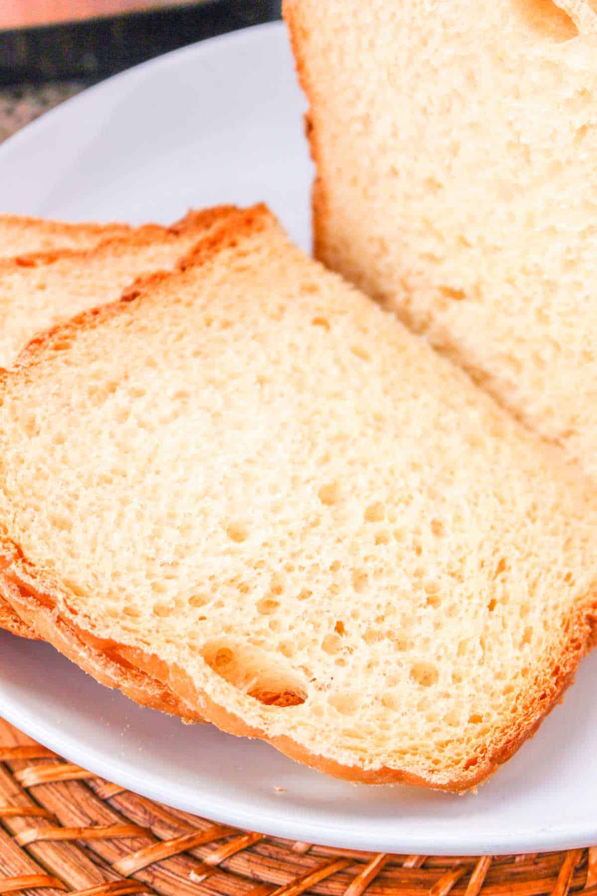Sliced bread on a plate, perfect for sandwiches.