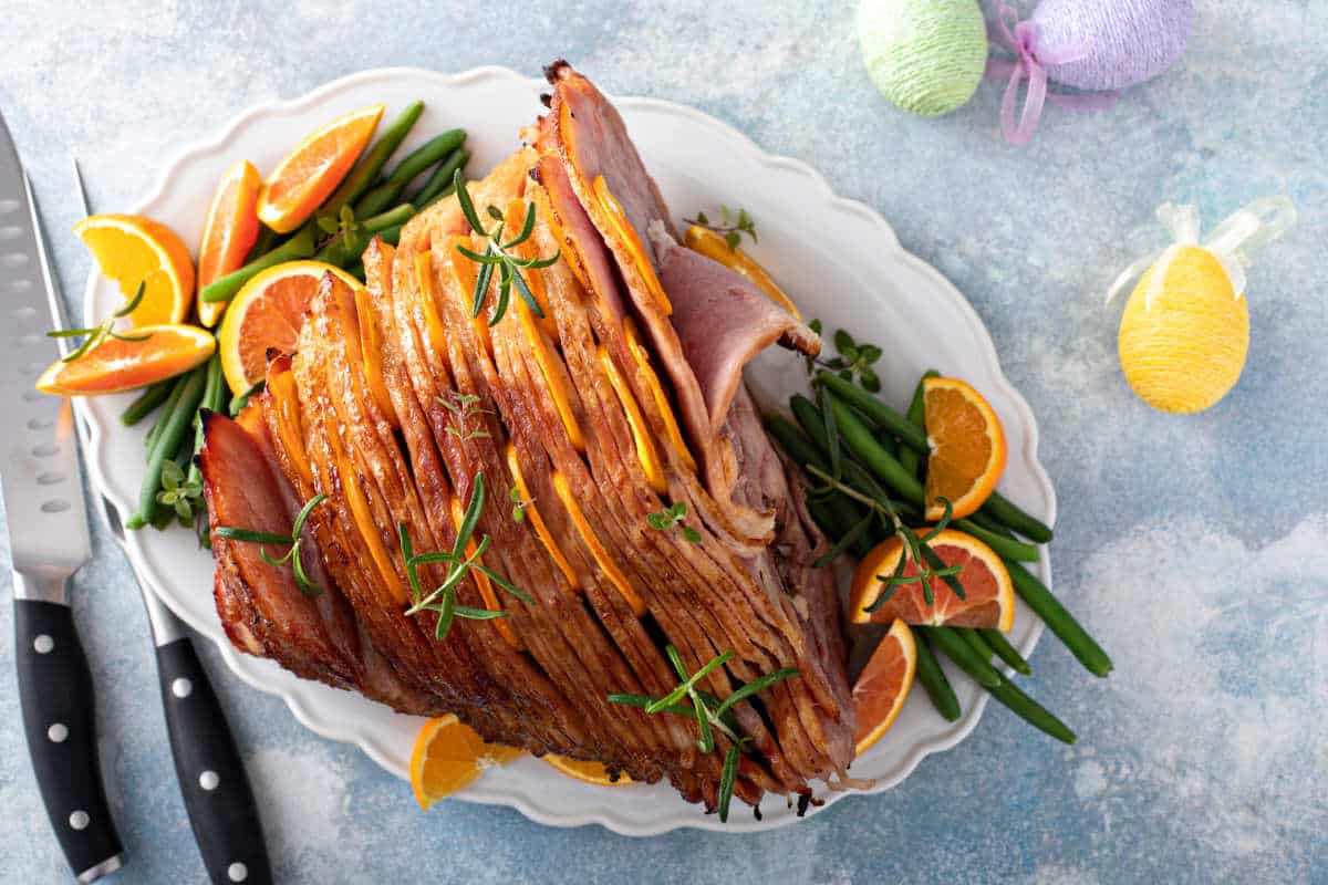 Traditional Easter ham spiral sliced with honey glaze stuffed with oranges and rosemary.