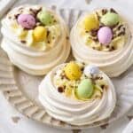 Filled mini Easter Pavlova nests with cheesecake filling and Cadbury Mini eggs.