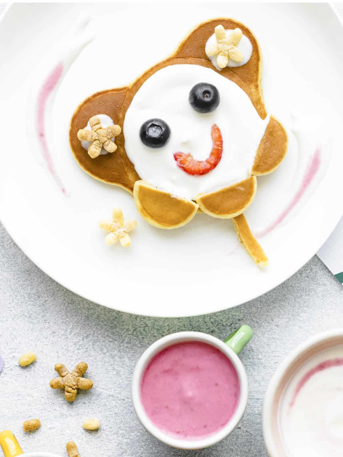 Cute breakfast, kids pancakes and chocolate cereal.