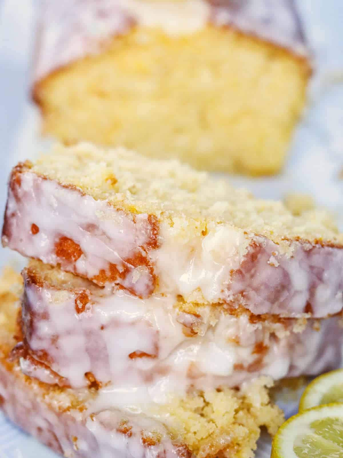 lemon loaf cake with icing drizzled on top.